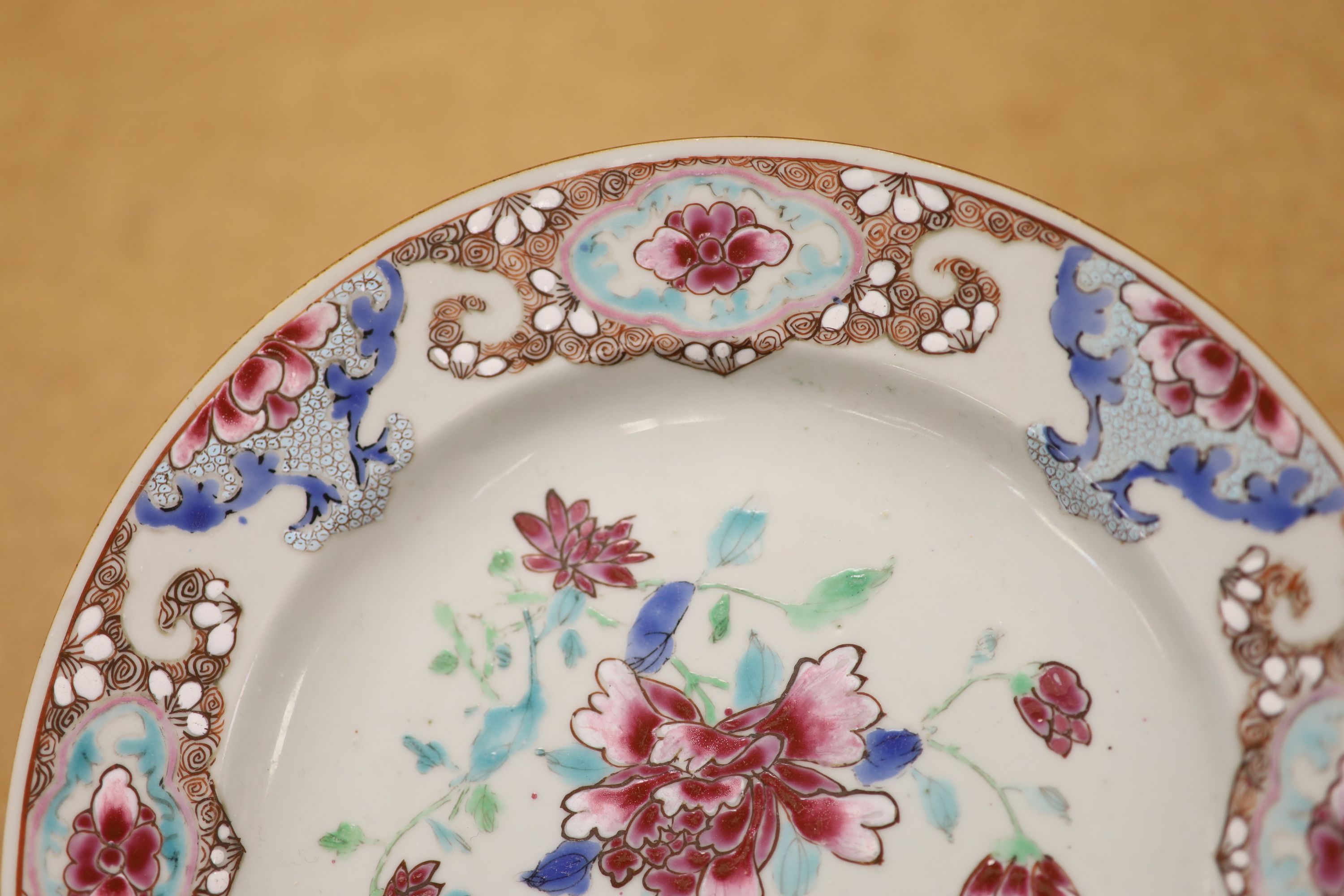 A pair of 18th century Chinese famille rose plates and another similar, largest diameter 22.5cm (damage)